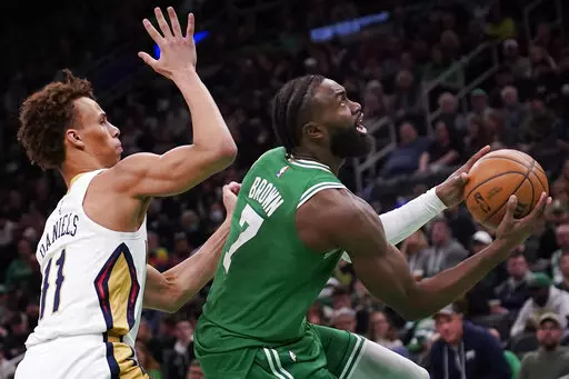 Boston Celtics guard Jaylen Brown (7) drives to the basket past New Orleans Pelicans guard Dyson Daniels (11) during the second half of an NBA basketball game, Wednesday, Jan. 11, 2023, in Boston. (AP Photo/Charles Krupa)