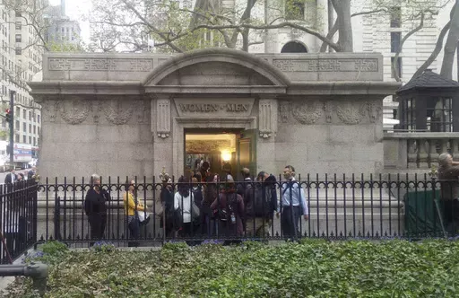 People line up to use a free public restroom, April 27, 2017, in New York. New York City Mayor Eric Adams announced Monday, June 3, 2024, a plan to build 46 new restrooms and renovate 36 existing ones located in city parks, adding to the city's roughly 1,000 such facilities over the next five years. (AP Photo/Verena Dobnik, File)
