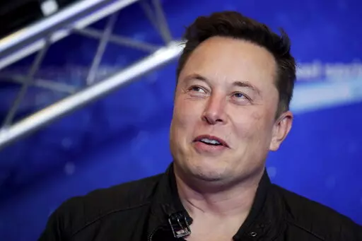 Tesla and SpaceX CEO Elon Musk arrives on the red carpet for the Axel Springer media award in Berlin on Dec. 1, 2020. Musk says he has lined up $46.5 billion in financing to buy Twitter, and he’s trying to negotiate an agreement with the company. The Tesla CEO says in documents filed Thursday, April 21, 2022 with U.S. securities regulators that he’s exploring a tender offer to buy all of the social media platform’s common stock for $54.20 per share in cash.   (Hannibal Hanschke/Pool Photo 