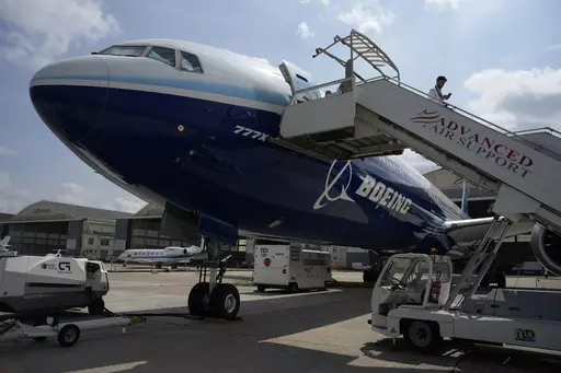 A man walks down the steps of the Boeing 777X airplane during the Paris Air Show in Le Bourget, north of Paris, France, Monday, June 19, 2023. Airlines are facing increasing pressure to cut their climate-changing emissions. That made sustainable aviation fuel a hot topic this week at the Paris Air Show, a major industry event. Sustainable fuel made from food waste or plant material is aviation's best hope for reducing emissions in the next couple of decades. (AP Photo/Lewis Joly, File)