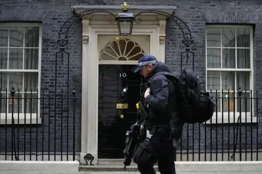 A police officer walks past 10 Downing Street in London, Tuesday, Jan. 25, 2022. London police say they are now investigating Downing Street parties during lockdown. Metropolitan Police Commissioner Cressida Dick revealed an investigation was underway in a statement before the London Assembly on Tuesday. Dick said Scotland Yard is now investigating "a number of events" at Downing Street. (AP Photo/Kirsty Wigglesworth)
