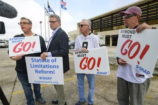 Members of SNAP, the Survivors Network of those Abused by Priests, including, from left, Kevin Bourgeois, John Gianoli, Richard Windmann and John Anderson, hold signs during a conference in front of the New Orleans Saints training facility, Jan. 29, 2020, in Metairie, La. Louisiana’s Supreme Court agreed Friday, May 10, 2024, to reconsider its recent ruling that wiped out a state law giving adult victims of childhood sexual abuse a renewed opportunity to file damage lawsuits. (AP Photo/Matthew