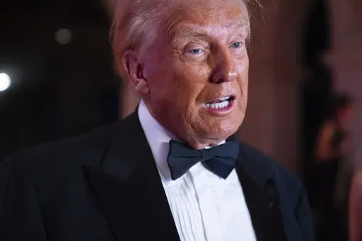 President-elect Donald Trump speaks to reporters before a New Year's Eve party at Mar-a-Lago, Tuesday, Dec. 31, 2024, in Palm Beach, Fla. (AP Photo/Evan Vucci)