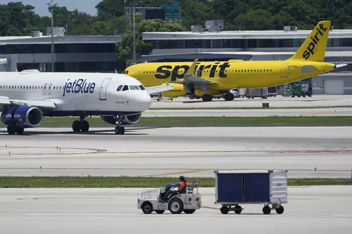 A JetBlue Airways Airbus A320, left, passes a Spirit Airlines Airbus A320 as it taxis on the runway, July 7, 2022, at the Fort Lauderdale-Hollywood International Airport in Fort Lauderdale, Fla. JetBlue and Spirit Airlines are ending their proposed $3.8 billion combination after a court ruling blocked their merger. JetBlue said Monday, March 4, 2024 that even though both companies still believe in the benefits of a combination, they felt they were unlikely to meet the required closing conditions