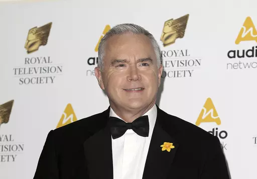 Journalist Huw Edwards poses for photographers upon arrival at the Royal Television Society Programme Awards at the Grosvenor Hotel in London, Tuesday, March 21, 2017. London police say there's no evidence that a BBC presenter who allegedly paid a teenager for sexually explicit photos committed a crime. The Metropolitan police issued the statement Wednesday, July 12, 2023 as the wife of Huw Edwards identified him as the presenter. (AP Photo/Tim Ireland, File)
