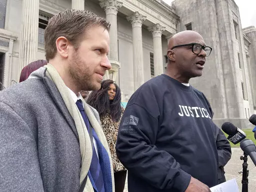 Attorney Richard Davis, left, of the Innocence Project New Orleans, stands next to Raymond Flanks outside the New Orleans criminal courthouse on Thursday, Nov. 17, 2022. A judge vacated Flanks' conviction in a 1983 murder and set him free, ending his nearly four decades in prison, after prosecutors and defense lawyers agreed that evidence favorable to him was withheld from his attorneys in the 1980s. (AP Photo/Kevin McGill)