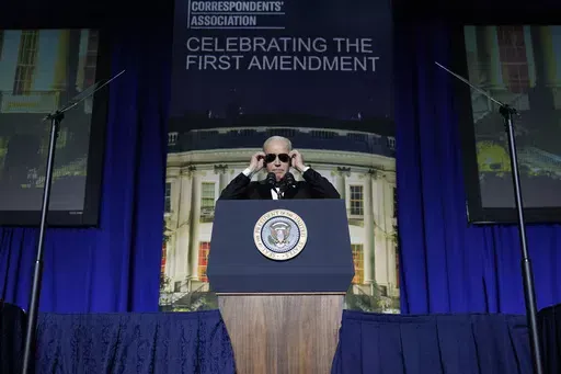 President Joe Biden puts on sunglasses after making a joke about becoming the "Dark Brandon" persona during the White House Correspondents' Association dinner at the Washington Hilton in Washington, April 29, 2023. Both presidential campaigns this year have embraced digital memes, the lingua franca of social media. (AP Photo/Carolyn Kaster, File)