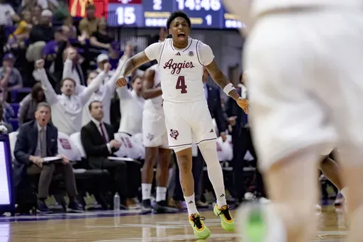 Texas A&M guard Wade Taylor IV (4) reacts after a three-point basket against LSU during the first half of an NCAA college basketball game in Baton Rouge, La., Saturday, March 8, 2025. (AP Photo/Matthew Hinton)