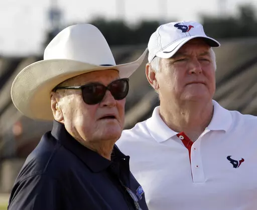 Houston Texans defensive coordinator Wade Phillips, right, and his father, Bum Phillips look on before an NFL football training camp practice Aug. 3, 2011, in Houston. Bum lost two AFC championship games as head coach of the Houston Oilers. His son Wade coached 42 years in the NFL as both a head coach and longtime defensive coordinator, reaching three Super Bowls and winning only one. (AP Photo/David J. Phillip, File)