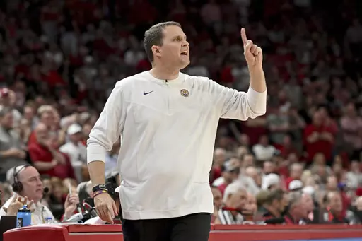 Then-LSU coach Will Wade gestures during the first half of the team's NCAA college basketball game against Arkansas, March 2, 2022, in Fayetteville, Ark. First-year McNeese State coach Wade has signed a five-year contract extension worth at least $700,000 per year. Wade resumed coaching this season for the first time since being fired by LSU in 2022 because of NCAA recruiting violations. (AP Photo/Michael Woods, File)