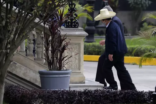 President-elect Pedro Castillo walks with interim President Francisco Sagasti at the government palace before a transition meeting, in Lima, Peru, Wednesday, July 21, 2021. Turmoil in Peru's government is boiling after President Pedro Castillo overhauled his Cabinet ton Jan. 22, for a third time in six months and then it quickly emerged his new prime minister has faced domestic violence claims. (AP Photo/Gudalupe Pardo, File)