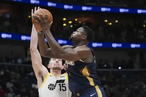 New Orleans Pelicans forward Zion Williamson (1) drives to the basket against Utah Jazz forward Drew Eubanks (15) in the second half of an NBA basketball game in New Orleans, Friday, Jan. 17, 2025. (AP Photo/Gerald Herbert)