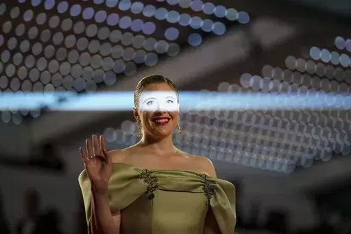 Jury president Greta Gerwig poses upon arrival at the premiere of the film 'The Shrouds' at the 77th international film festival, Cannes, southern, Monday, May 20, 2024. Daniel Cole, a freelance photographer who does extensive work for The Associated Press, mostly in southern France, spends the majority of his time covering hard news. But he takes great joy out of spending nearly two weeks each May in a tuxedo, covering the glamourous Cannes Film Festival, where he can push the creativity of his