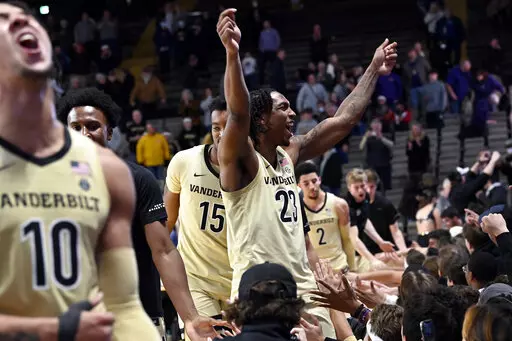 Vanderbilt forward Myles Stute (10) and guard Jamaine Mann (23) celebrate with fans after Vanderbilt defeated LSU in an NCAA college basketball game Saturday, Feb. 5, 2022, in Nashville, Tenn. (AP Photo/Mark Zaleski)