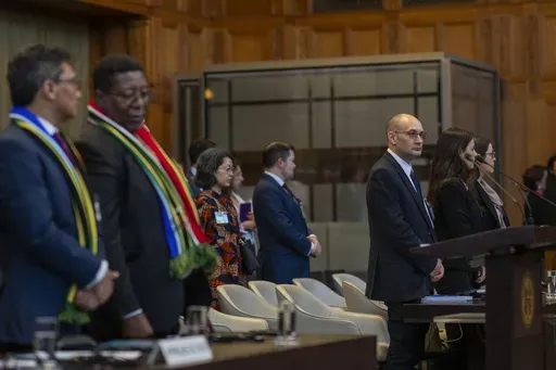 Front row from left, South Africa's agents Cornelius Scholtz, Vusimuzi Madonsela and Israel's agents Gilad Naom, Tamar Kaplan Tourgeman and co-agent Avigail Frisch Ben Avraham wait for the start of hearings at the International Court of Justice, in The Hague, Netherlands, Thursday, May 16, 2024. The U.N.'s top court opened two days of hearings in a case brought by South Africa to see whether Israel needs to take additional measures to alleviate the suffering in war-ravaged Gaza. (AP Photo/Peter 