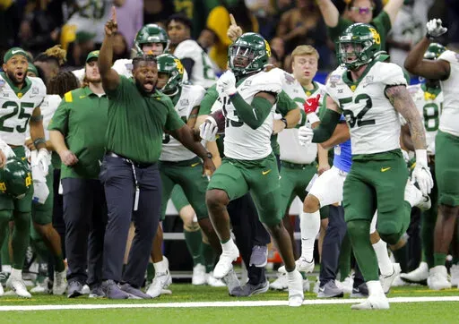 Baylor cornerback Al Walcott (13) runs 96 yards for a touchdown after intercepting a pass during the Sugar Bowl NCAA college football game against Mississippi Saturday, Jan. 1, 2022 in New Orleans. (David Grunfeld/The Times-Picayune/The New Orleans Advocate via AP)