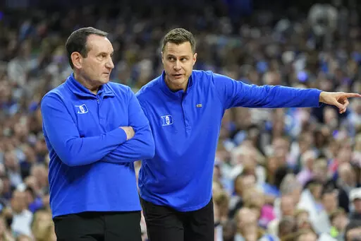 Duke assistant coach Jon Scheyer and head coach Mike Krzyzewski work during the first half of a college basketball game in the semifinal round of the Men's Final Four NCAA tournament, Saturday, April 2, 2022, in New Orleans. (AP Photo/David J. Phillip)