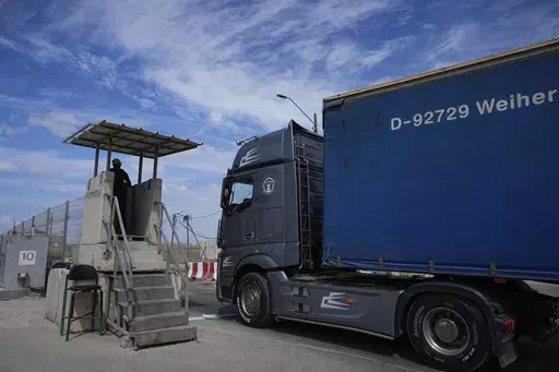 A truck carrying humanitarian aid for the Gaza Strip passes through the Kerem Shalom Crossing in southern Israel, Thursday, March 14, 2024. Under heavy U.S. pressure, Israel has promised to ramp up aid to Gaza dramatically, saying last week it would open another cargo crossing and surge more trucks than ever before into the besieged enclave. But days later, there are few signs of those promises materializing and international officials say famine is fast approaching in hard-hit northern Gaza. (A