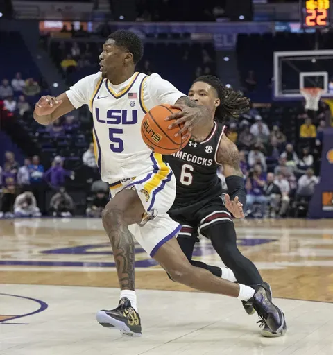 LSU guard Cam Carter (5) drives the ball past South Carolina guard Jamarii Thomas (6) during an NCAA college basketball game Tuesday, Feb. 18, 2025, in Baton Rouge, La. (Hilary Scheinuk/The Advocate via AP)