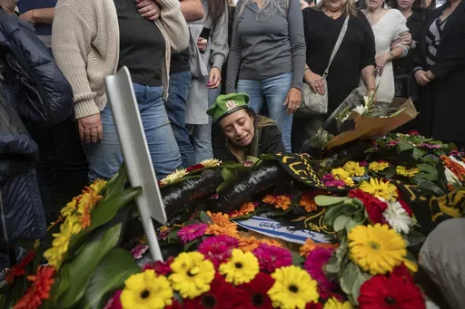 Gali, whose son, Sgt. Yahav Maayan, was killed in combat in the Gaza Strip, reacts next to his grave during his funeral at a military cemetery in Modiin, Israel, Sunday, Jan. 12, 2025. (AP Photo/Ohad Zwigenberg)