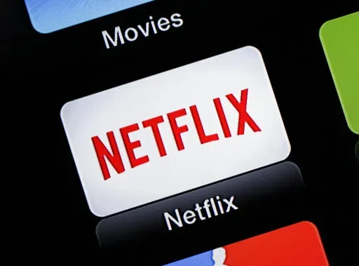 This June 24, 2015, file photo, shows the Netflix Apple TV app icon  in South Orange, N.J. Netflix is raising prices for its video streaming customers in the U.S. and Canada, less than a year and a half since its last price increase, as competition from other streaming services increases.  (AP Photo/Dan Goodman, File)