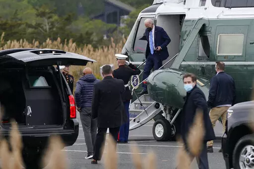 President Joe Biden steps off Marine One at Gordons Pond in Rehoboth Beach, Del., Monday, Dec. 27, 2021. (AP Photo/Patrick Semansky)