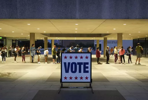 Voters wait in line at a polling place at the Lyndon B. Johnson School of Public Affairs in Austin, Texas, on election night, Nov. 8, 2022. Texas became the largest state Thursday, July 20, 2023, to resign from a bipartisan, multi-state effort aimed at preventing voter fraud by ensuring accurate voter lists, and is now the ninth GOP-led state to leave the effort since 2022. (Jay Janner/Austin American-Statesman via AP, File)