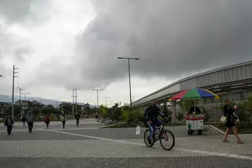 People walk outside of a metro station after a blackout affected the entire country, in Quito, Ecuador, Wednesday, June 19, 2024. In some sectors of the country the outage lasted 20 minutes, but media outlets and social media users reported that the problem continued in most cities. (AP Photo/Dolores Ochoa)