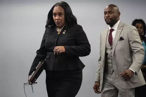 Fulton County District Attorney Fani Willis enteres a room in the Fulton County Government Center ahead of a news conference, Monday, Aug. 14, 2023, in Atlanta. Donald Trump and several allies have been indicted in Georgia over efforts to overturn his 2020 election loss in the state. (AP Photo/John Bazemore)