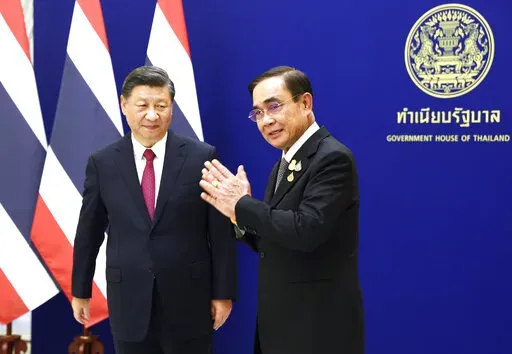 Chinese President Xi Jinping, left, meets with Thailand's Prime Minister Prayuth Chan-ocha, on the sidelines of the Asia-Pacific Economic Cooperation, APEC summit, at the Government House, Saturday, Nov. 19, 2022, in Bangkok, Thailand. (Athit Perawongmetha/Pool Photo via AP)