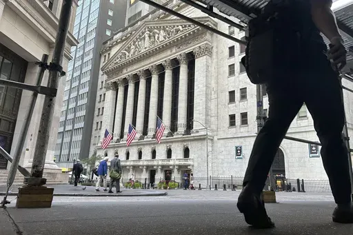 People pass the New York Stock Exchange on Aug. 27, 2024, in New York. (AP Photo/Peter Morgan, File)