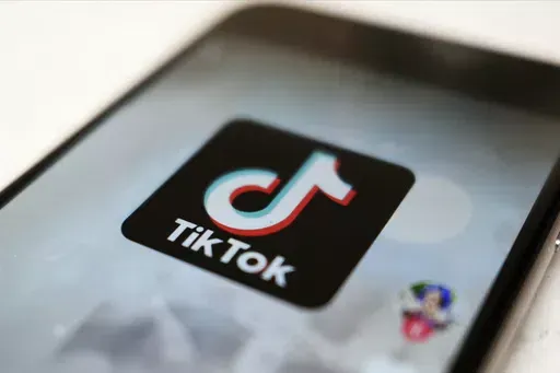 The TikTok logo is displayed on a smartphone screen in Tokyo on Sept. 28, 2020. TikTok says it's going to start automatically labeling content that's made by artificial intelligence when it's uploaded from certain platforms. TikTok says its efforts are an attempt to combat misinformation from being spread on its social media platform. The announcement came on ABC's “Good Morning America” on Thursday, May 9, 2024. (AP Photo/Kiichiro Sato, File)