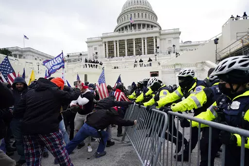 Violent insurrections loyal to President Donald Trump break through a police barrier at the Capitol in Washington. Over months, the House Select Committee investigating the Jan. 6 U.S. Capitol insurrection has issued more than 100 subpoenas, done more than 1,000 interviews and probed more than 100,000 documents to get to the bottom of the attack that day in 2021 by supporters of former President Donald Trump. (AP Photo/Julio Cortez, File)