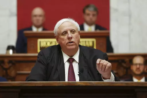 West Virginia Gov. Jim Justice delivers his annual State of the State address in the House Chambers at the state capitol in Charleston, W.Va., on Jan. 11, 2023. The House of Delegates passed a bill Tuesday, Feb. 14, 2023, that would split the Department of Health and Human Resources into three new departments. Justice last year vetoed a bill passed by lawmakers that would have split the agency into two parts. (AP Photo/Chris Jackson, File)