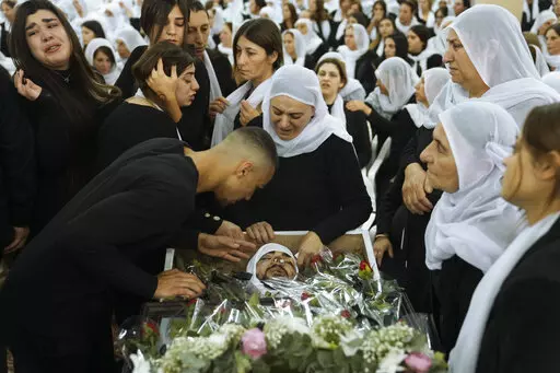 Members of the Israeli Druze minority mourn around the body of Tiran Fero, 17, during his funeral in Daliyat al-Carmel, Israel, on Nov. 24, 2022. Israel’s military says its prosecutor has filed indictments against two soldiers who allegedly hurled an explosive device at a Palestinian home in the occupied West Bank last month. The indictment announced Thursday, Dec. 29, said the two soldiers acted out of revenge for the kidnapping of the body of an Israeli schoolboy in the flashpoint West Bank 