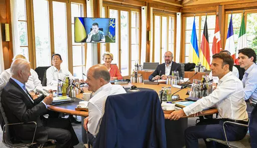 From front center clockwise, Germany's Chancellor Olaf Scholz, US President Joe Biden, Britain's Prime Minister Boris Johnson, Japan's Prime Minister Fumio Kishida, European Commission President Ursula von der Leyen, European Council President Charles Michel, Italy's Prime Minister Mario Draghi, Canada's Prime Minister Justin Trudeau and France's President Emmanuel Macron have taken seat at a round table as Ukraine's President Volodymyr Zelensky addresses the G7 leaders via video link during the
