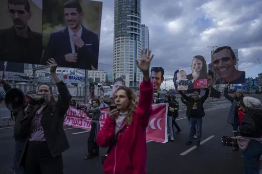 Relatives and supporters of Israelis held hostage in the Gaza Strip, hold photos depicting their faces during a protest demanding their release from Hamas captivity, in Tel Aviv, Israel, Thursday, Feb. 13, 2025. (AP Photo/Oded Balilty)