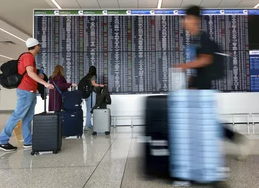 Passengers arrive at Terminal C at Orlando International Airport, Monday, March 18, 2024, in Orlando, Fla. U.S. airlines are trying to kill a new rule requiring them to disclose fees more quickly when consumers shop for flights. The airlines filed a lawsuit in federal appeals court against the Transportation Department, which issued the rule last month. (Joe Burbank/Orlando Sentinel via AP, File)