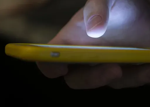 A man uses a cell phone in New Orleans on Aug. 11, 2019. A recent uptick in scams targeting older adults has seniors wondering who’s really calling them. As the most common type of reported Social Security scam, imposters fool beneficiaries into thinking they are providing information to the agency. (AP Photo/Jenny Kane, File)