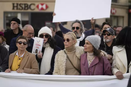 French actresses Isabelle Adjani, with the white wooly hat, Ariane Ascaride, left, Emmanuelle Beart, center, and French singer Yale Naim, right, attend a silent march for peace between Israelis and Palestinians, in Paris, Sunday, Nov. 19, 2023. Hundreds of French performers from different cultural and religious backgrounds called for a silent march Sunday in central Paris to call for peace between Israelis and Palestinians and unity among French people. (AP Photo/Thibault Camus)
