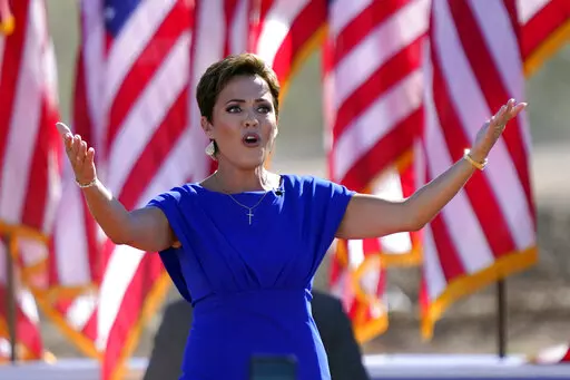 Arizona Republican gubernatorial candidate Kari Lake arrives to a rally with former President Donald Trump on Oct. 9, 2022, in Mesa, Ariz. The Republicans running for Arizona's three top statewide offices have said they would not have signed off on the presidential results if they had held office in 2020 and have signaled that they want to overhaul the battleground state's elections.(AP Photo/Matt York, File)