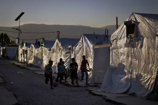 Syrian children play soccer by their tents at a refugee camp in the town of Bar Elias in the Bekaa Valley, Lebanon, July 7, 2022. Against the backdrop of a worsening economic crisis and political stalemate, Lebanese officials have launched a crackdown on the country's Syrian refugees. (AP Photo/Bilal Hussein, File)