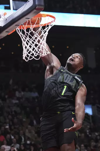 New Orleans Pelicans forward Zion Williamson (1) dunks against the Toronto Raptors during the first half of an NBA basketball game in Toronto on Tuesday, March 5, 2024.(Nathan Denette/The Canadian Press via AP)