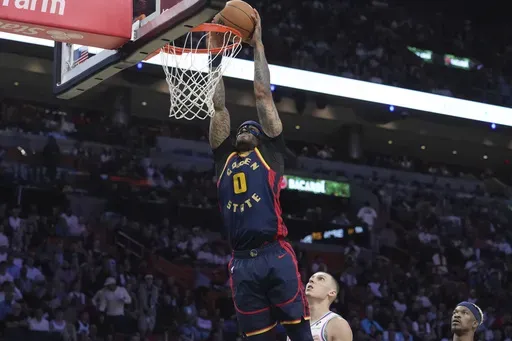 Golden State Warriors guard Gary Payton II (0) dunks the ball during the second half of an NBA basketball game =ah, Tuesday, March 25, 2025, in Miami. (AP Photo/Marta Lavandier)