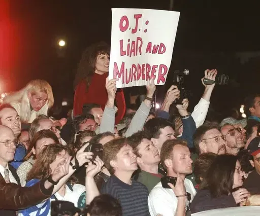 A crowd reacts to O.J. Simpson leaving Los Angeles County Superior Court, Tuesday, Feb. 4, 1997, in Santa Monica, Calif. after hearing the verdict in the wrongful-death civil trial against O.J. Simpson. Simpson was found liable in the deaths of Nicole Brown Simpson and Ron Goldman. Simpson, the decorated football superstar and Hollywood actor who was acquitted of charges he killed his former wife and her friend but later found liable in a separate civil trial, has died. He was 76. (AP Photo/Susa