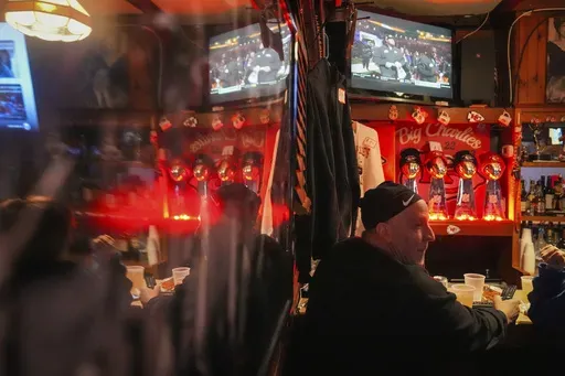 Big Charlie's Saloon Owner Paul Staico sits with customers at his bar in Philadelphia, Monday, Feb. 3, 2025, ahead of the upcoming Super Bowl 59 between the Kansas City Chiefs and the Philadelphia Eagles. (AP Photo/Matt Rourke)