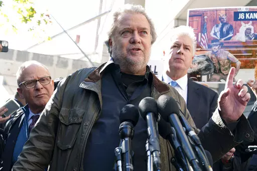 Steve Bannon, center, a longtime ally of former President Donald Trump and convicted of contempt of Congress,  accompanied by his attorneys David Schoen, left, and Evan Corcoran, right, speaks to the media as he leaves the federal courthouse on Friday, Oct. 21, 2022, in Washington. Bannon was sentenced to 4 months behind bars for defying a Jan. 6 committee subpoena. ( AP Photo/Jose Luis Magana)