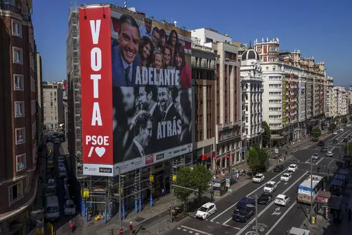 A giant electoral poster depicting Spain's Prime Minister and Socialist candidate Pedro Sánchez, top, and conservative PP party leader Alberto Nunez Feijóo and VOX far-right party leader Santiago Abascal is displayed on a building at the Gran Via avenue in Madrid, Spain, Monday, July 10, 2023. A general election on Sunday July 23, 2023, could make Spain the latest European Union member to swing to the right. Prime Minister Pedro Sánchez called the early election after his Spanish Socialist Wo