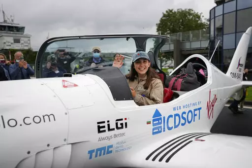 Belgian-British teenager Zara Rutherford waves from her Shark ultralight plane prior to take off at the Kortrijk-Wevelgem airfield in Wevelgem, Belgium, Aug. 18, 2021. Rutherford is set to land in Kortrijk, Belgium on Monday, Jan. 17, 2022, in the hopes of completing her trek around the world as the youngest woman ever, beating the mark of American aviator Shaesta Waiz, who was 30 when she set the previous benchmark. (AP Photo/Virginia Mayo, File)