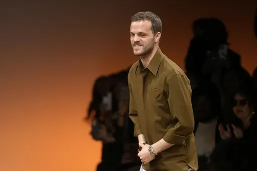 Creative director Matthieu Blazy accepts applause after the conclusion of the Bottega Veneta women's Fall-Winter 2024-25 collection presented in Milan, Italy, Feb. 24, 2024. (AP Photo/Luca Bruno, file)
